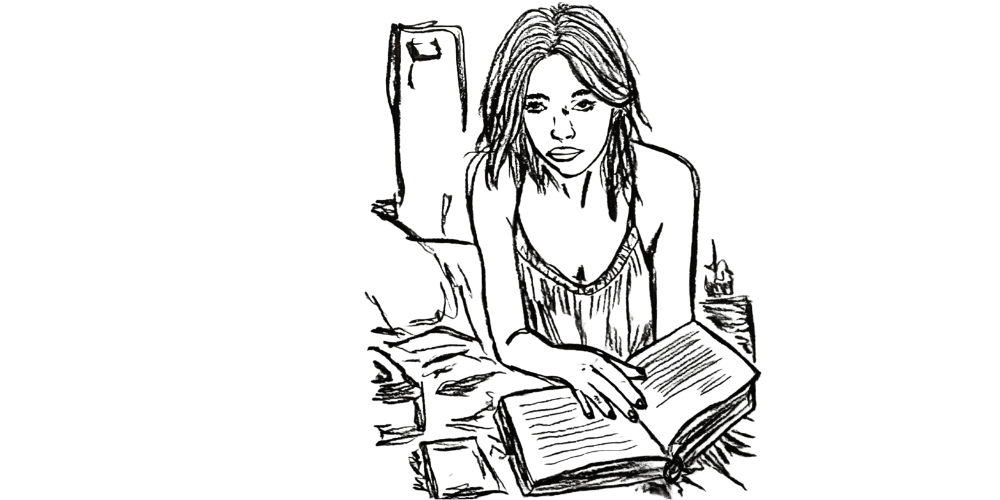 Woman journaling with candlelight