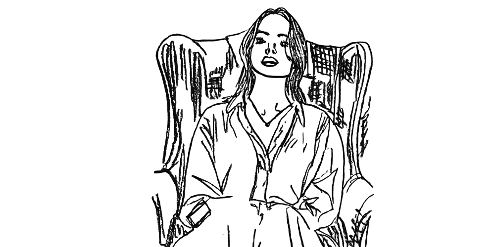 A woman sitting upright in a high-back chair, open posture