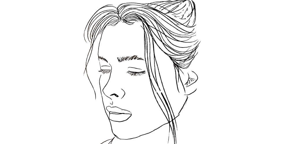 Finding meaning in what’s already here — woman journaling softly with warm candlelight (Mibosma).